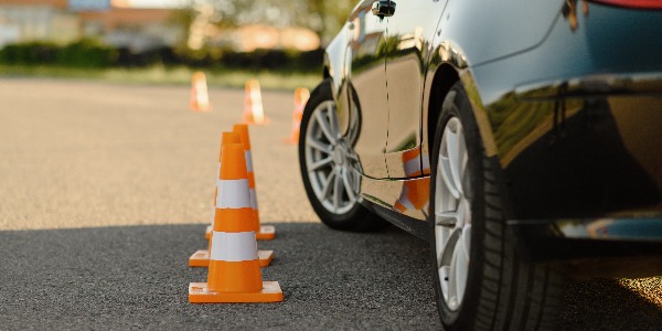 Car and traffic cones, driving school concept