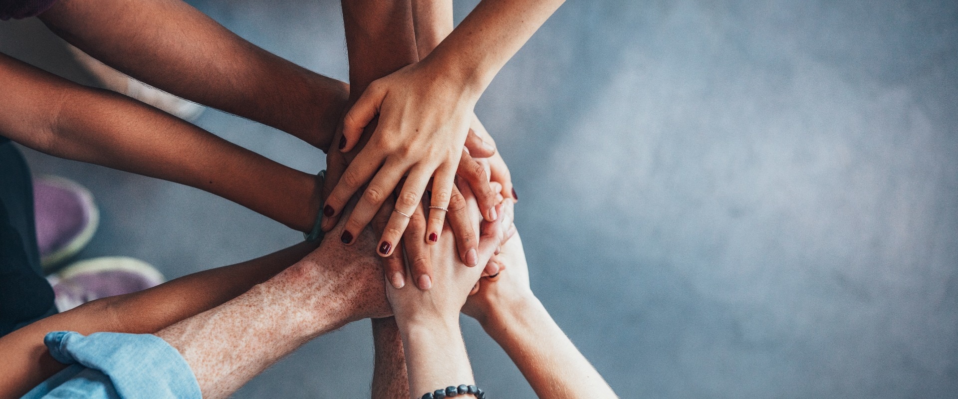 Stack of hands showing unity and teamwork